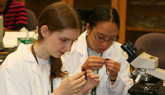 Two USABO students studying specimens in the lab
