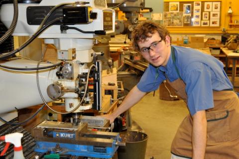 Teen boy in machine shop