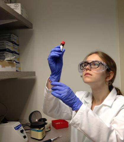Girl in lab examining test tube